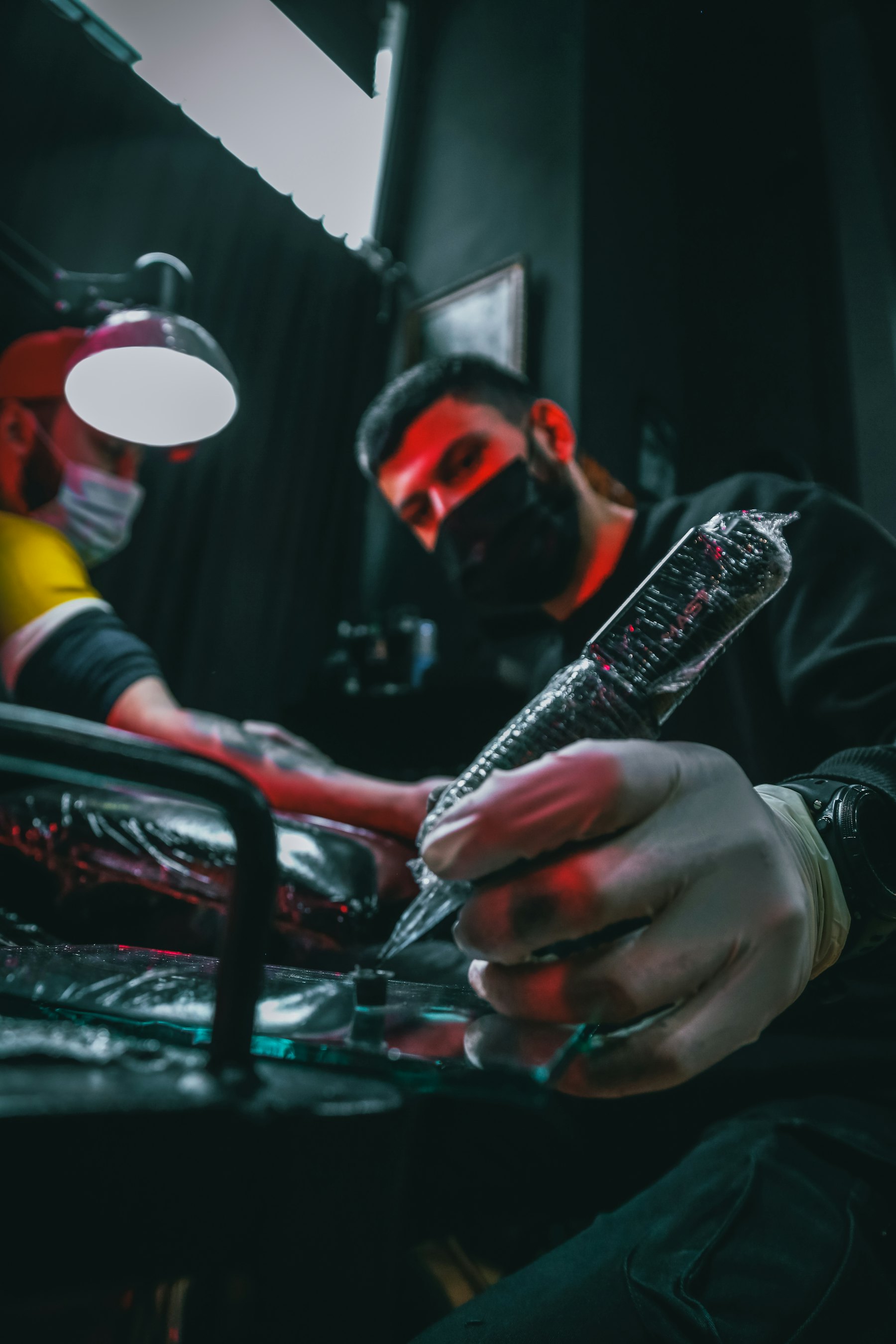 Tattooer mixing ink before the session
